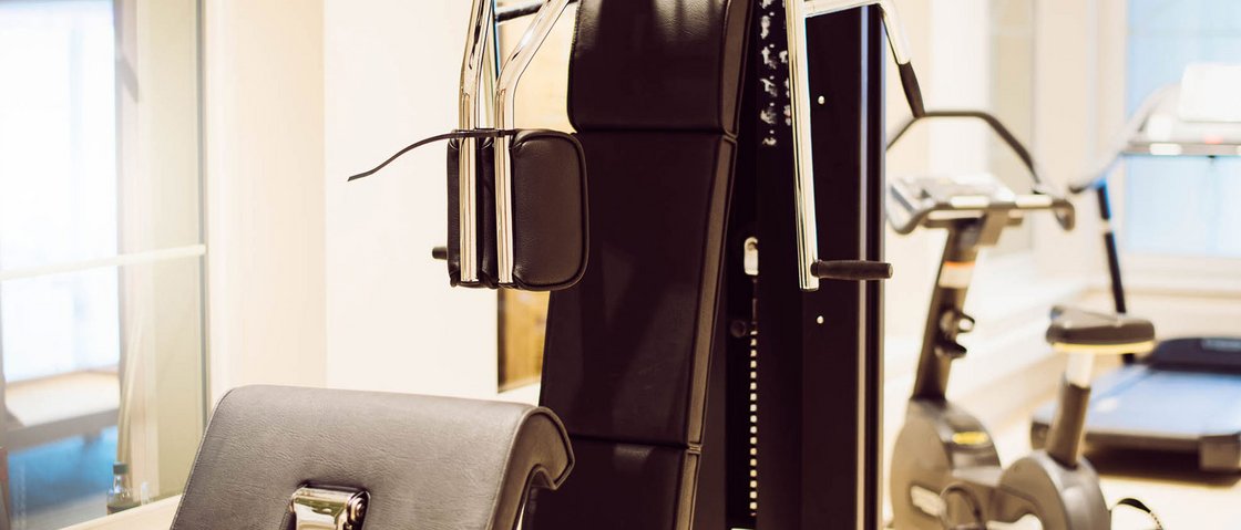 Rejuvenation at our 4-star wellness hotel in Tyrol Exercise machines and stationary bike in a bright gym room