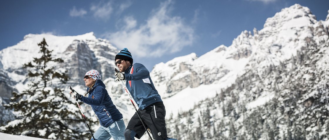 That little extra on your ski holiday in Stubaital Couple cross-country skiing in snowy mountain landscape with blue sky